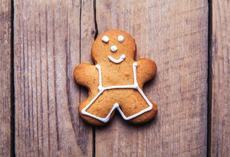Christmas homemade gingerbread man on wooden table