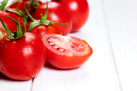 red tomatoes on wooden tableの写真素材