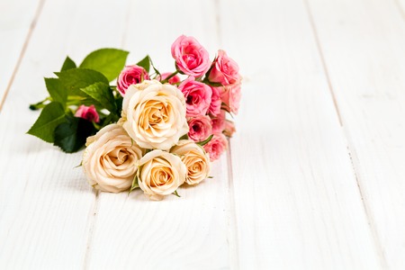 roses on white wooden planks background. flowersの写真素材