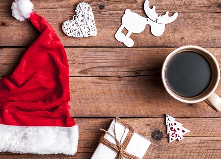 Cup of coffee and Santas hat, Christmas set, gift and Christmas tree. Celebrationの写真素材