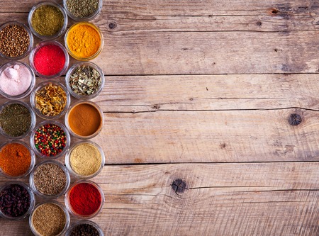 Spices in jars on wooden background. Foodの写真素材
