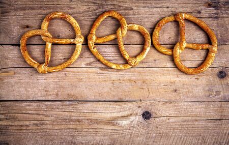 Homemade pastries. Pretzel on wooden background. Foodの写真素材