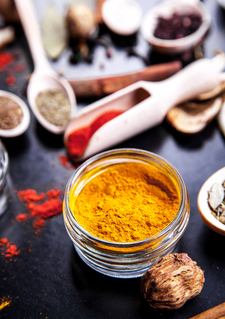 Spices on black background in special jars. Foodの写真素材