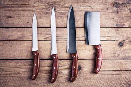 Beautiful knives with wooden handle, on an old table. Kitchen, cooking, cuttingの写真素材