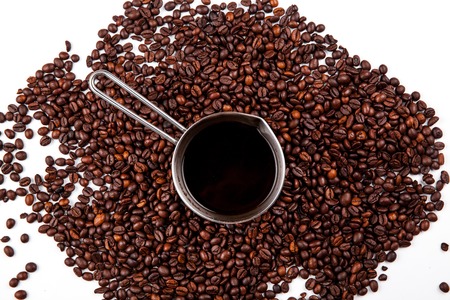 Turk with coffee beans isolated on white background