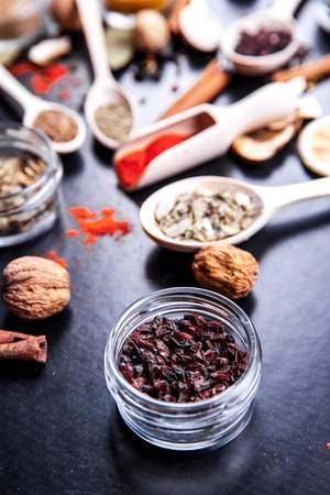 Spices on black background in special jars.の写真素材