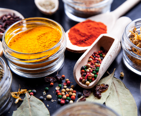 Spices on black background in special jars. Foodの写真素材