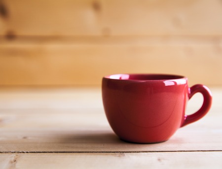 Red coffee cup on wooden tableの写真素材