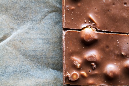 Chocolate with hazelnuts candy as backgroundの写真素材