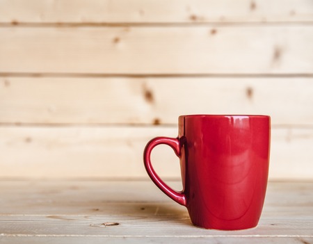 Red coffee cup on wooden tableの写真素材