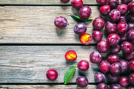 fresh plums on wooden tableの写真素材