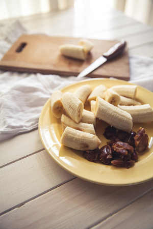Sliced bananas and figs on a wooden table. Healthy food. Organics. Fruitの写真素材
