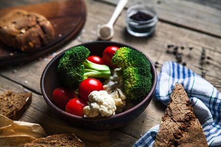 Fresh bread with vegetables and spices on wooden background. Food, empty space for text.