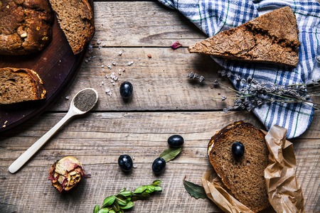 grapes, wheat, bread in wood table. dried roses. flowers. fruits, grains, foodの写真素材