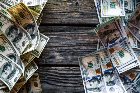 money on a wooden background. lot 100 dollars, business composition
