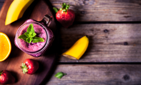 Blueberry smoothies on a wooden background with fruits.の写真素材