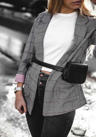 Fashion young woman wearing black hat checkered coat jacket handbag aの写真素材