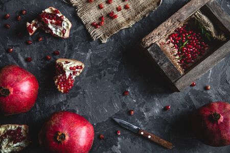 Beautiful composition of pomegranates on a dark background with a towel, healthy food, fruit aの写真素材