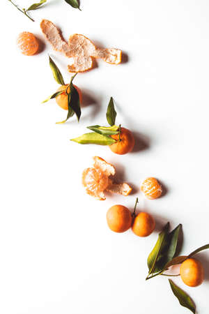 Oranges fruits composition with green leaves and slice on white wooden background, top view aの写真素材