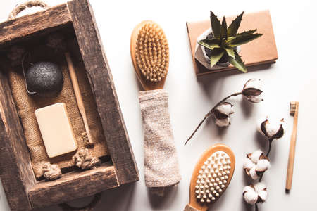 Natural brushes made of wood and soap on the background of concrete, bamboo toothbrushes and body brush, handmade soap with loofah, eco-friendly lifestyle concept and zero waste, copy spaceの写真素材