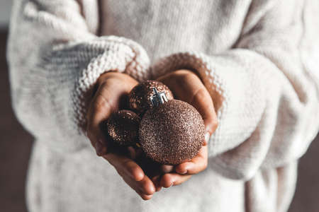 A child holding red Christmas ball. Christmas card design. Copy space. Close-upの写真素材