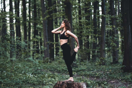 athletic girl running in the Park and doing exercises Jogging, health exerciseの写真素材