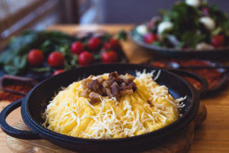 banosh, a traditional Ukrainian corn grain dish with fat and sheep cheese. style rustic. selective focus.の写真素材