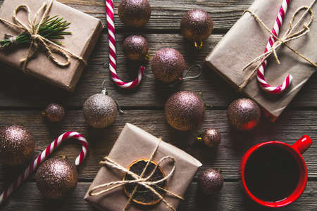 Christmas background with fir tree, present box and decorations on wooden background. Top viewの写真素材