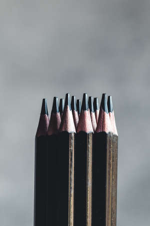 Simple graphite pencils on grey background. Black pencils, space for textの写真素材