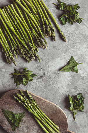 Asparagus on a cutting board. Healthy food, health on a concrete background.の写真素材