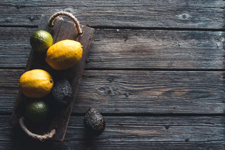 Avocado and Lemon with Knife on Old wooden Board, healthy food, vegetarianism, wellnessの写真素材