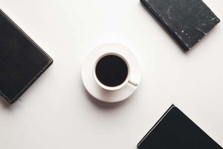 Office desk table with supplies, coffee cup and flower. Top viewの写真素材