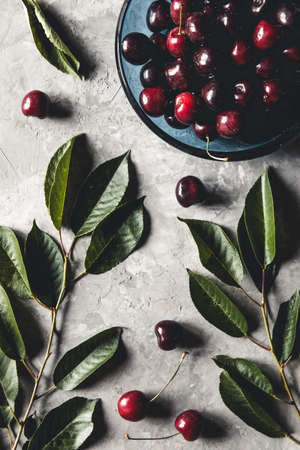 Sweet organic berries on a light concrete background. Top view with copy space.の写真素材