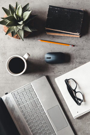 laptop and book, coffee on gray background, Top view of office desk on texturedの写真素材