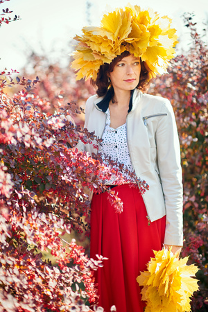 Young pretty woman in the autumn park.の写真素材