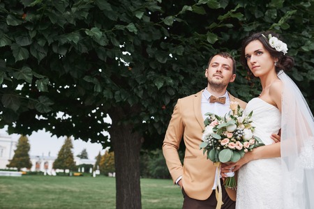 Young wedding couple enjoying romantic moments outside on a summer meadowの写真素材