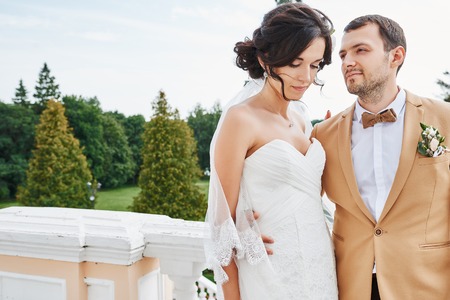 Young wedding couple enjoying romantic moments outside on a summer meadowの写真素材