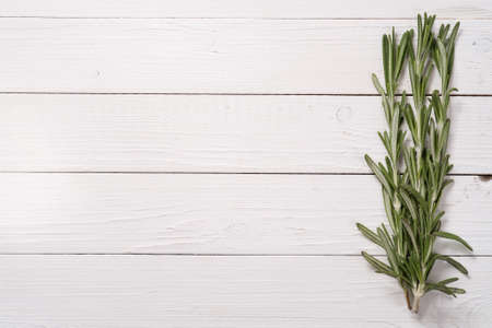 Rosemary on a wooden table, top viewの写真素材