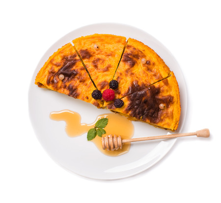 Pumpkin pie with berries and honey isolated on white backgroundの写真素材