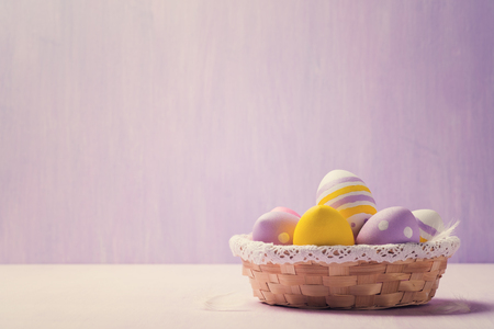 Easter eggs in a wicker basket. Space for textの写真素材