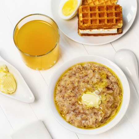 Healthy breakfast - cereal with flakes of wheat, oats, barley and rye with orange juice, top view