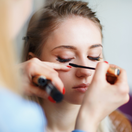 Process of dyeing the eyelashes of a young girl. Close-upの写真素材
