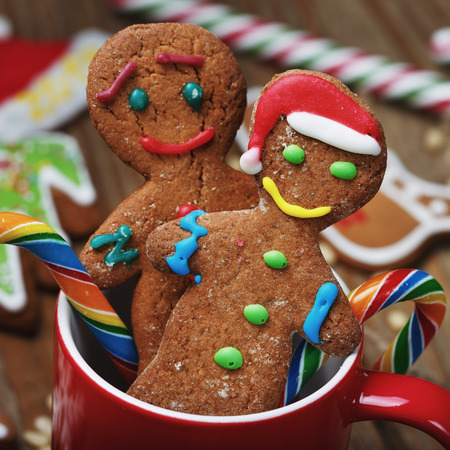 Gingerbread men with sweets in a mug. Christmas dessert