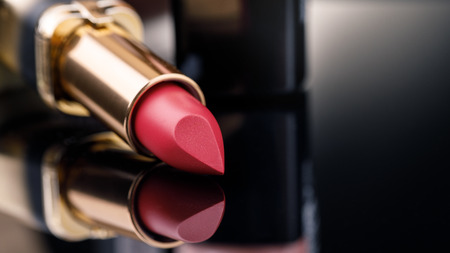 Fashion Colorful Lipsticks over black background with space for text. Lipstick tints palette, Professional Makeup and Beauty. Lipgloss closeupの写真素材