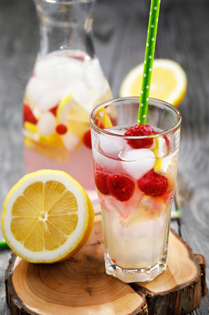 Fresh drink with raspberries, slices of lemon and the addition of iceの写真素材