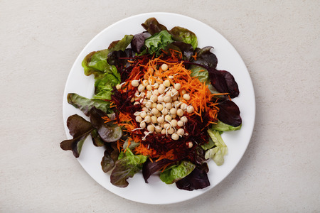 Useful recipes: a dish of sprouted peas, beets, carrots and lettuce leaves. Top viewの写真素材