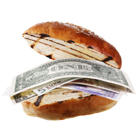 Hamburger with money, as a filling, dollars, euros, pounds and rubles isolated on white backgroundの写真素材