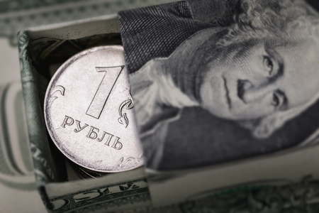 Russian ruble in a box made from American dollars, close-upの写真素材