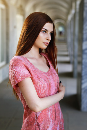 Portrait of a young girl posing in a dress made in author's technique from merino wool, closeupの写真素材