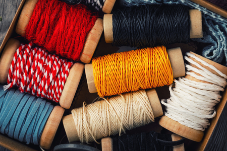 Background of multicolored coils with thread, top viewの写真素材